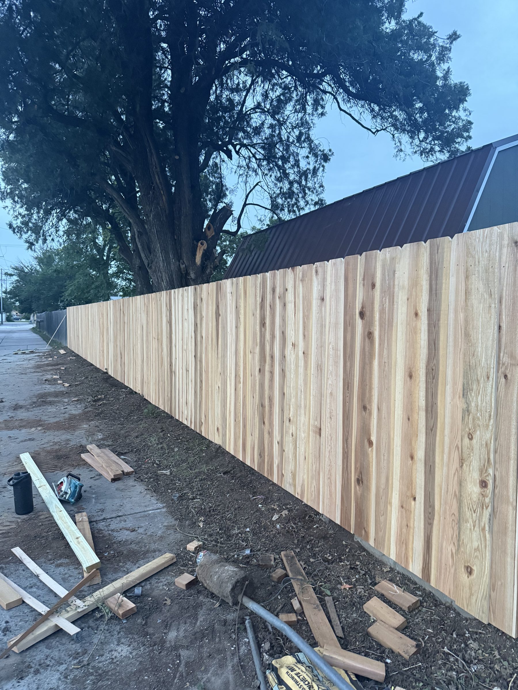 Fence installation in progress, posts set