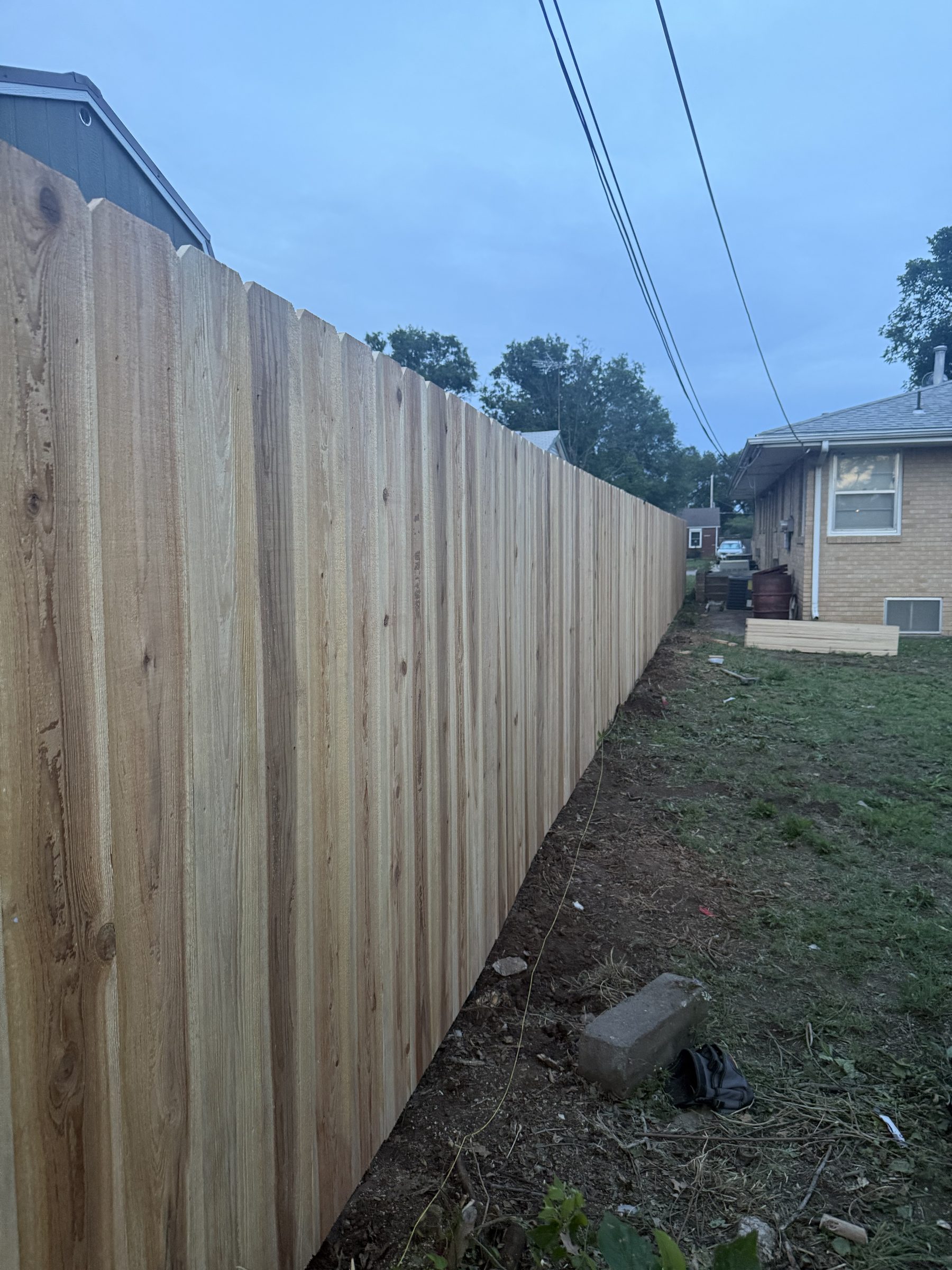 Cedar fence with decorative top pickets